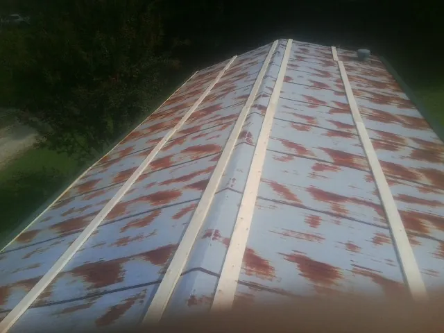 Rusted metal roof panels with new wood purlins before replacement — Storm Damage Roof Repair in Coronado by Roofing Brothers